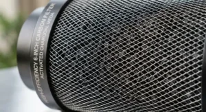 Close-up of a high-efficiency 6-inch carbon filter showing the activated charcoal mesh