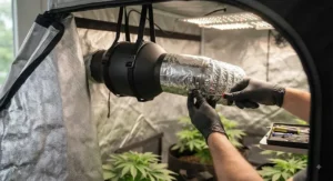Connecting aluminum ductwork to an inline duct fan for grow tent ventilation to ensure airtight seals.